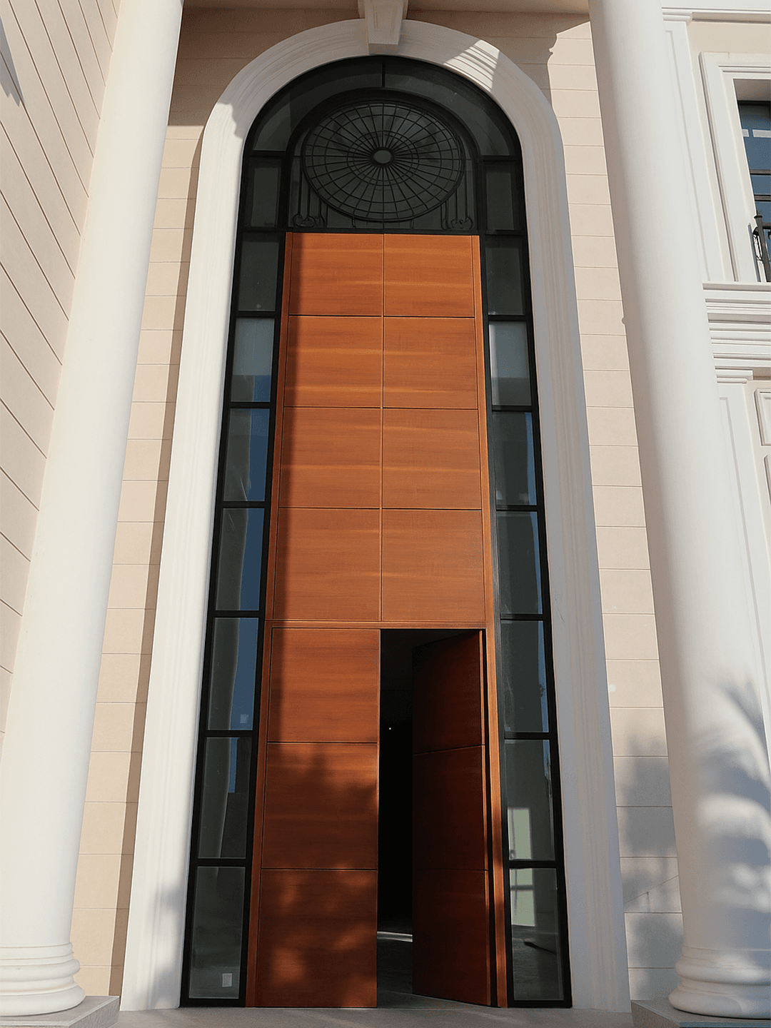Wooden pivot door installed at a Qatari villa entrance